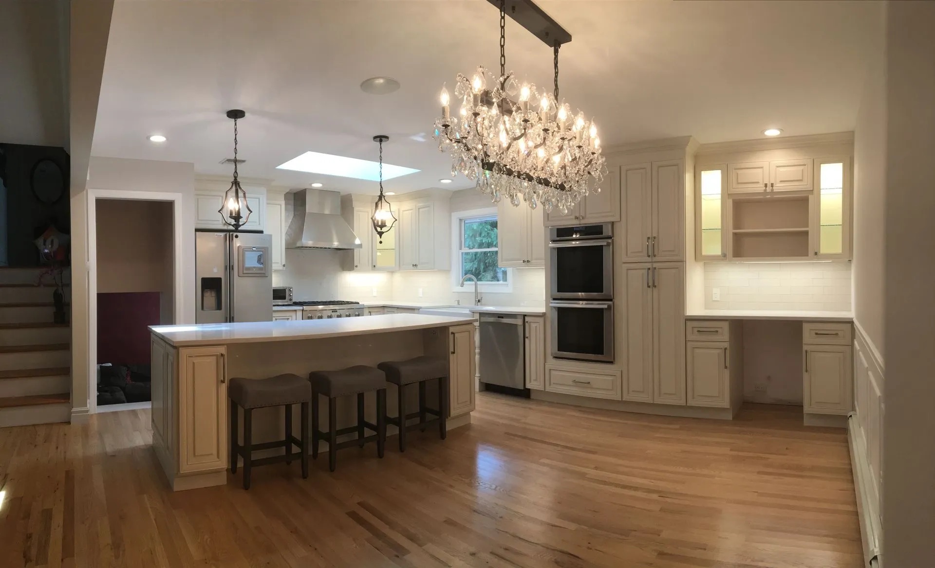 Elegant Kitchen with Crystal Chandelier in Saddle River, NJ by Modern Heritage Remodelers